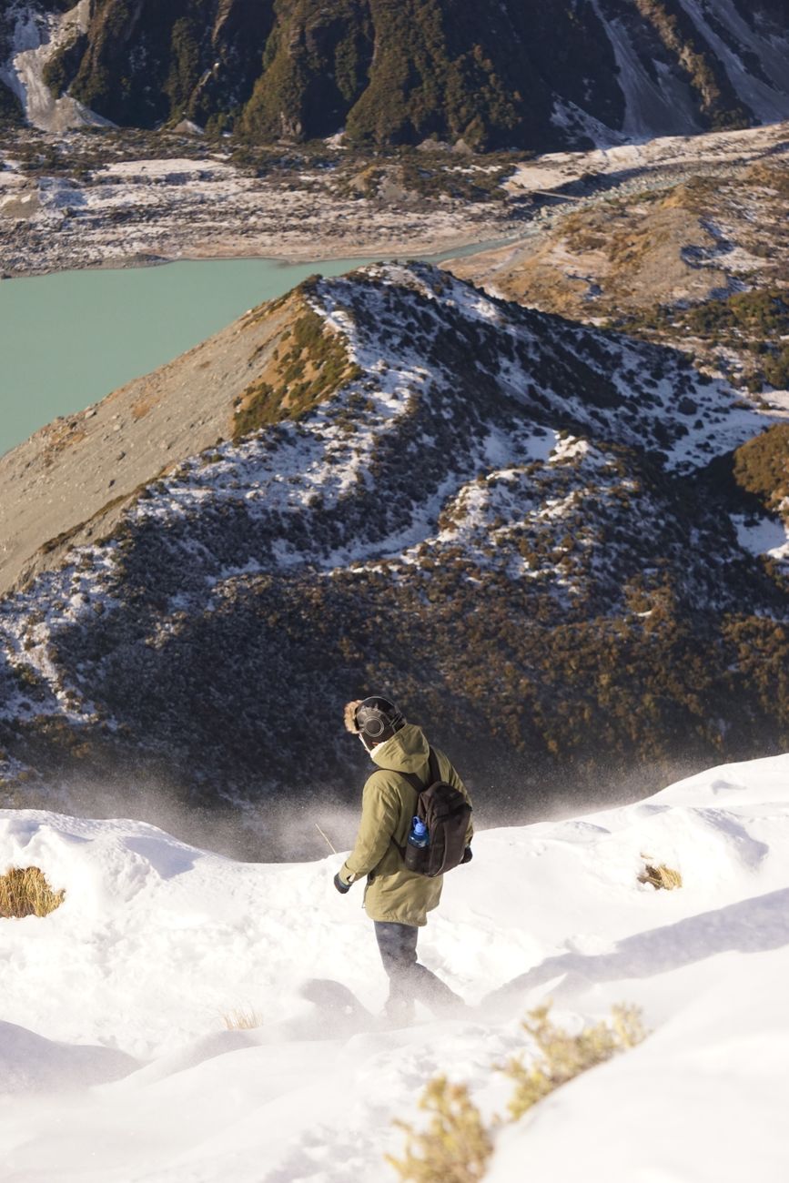 Hikers crossing snowy alpine pass in New Zealand