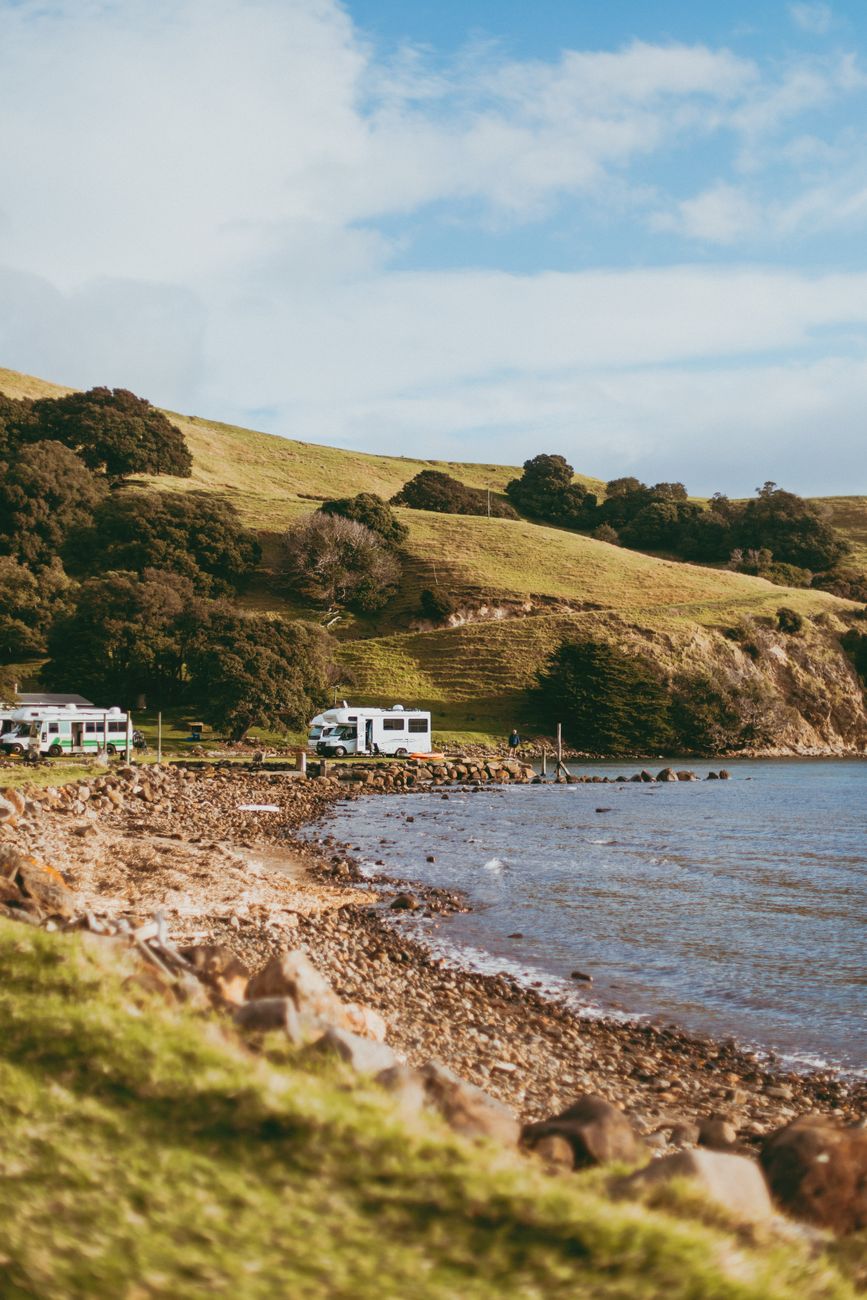 Campervan parked along scenic coastal highway in New Zealand