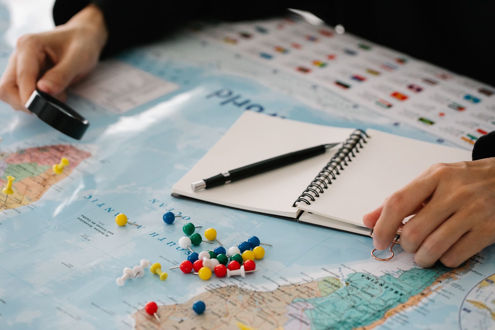 Custom itinerary map and notebook on wooden table
